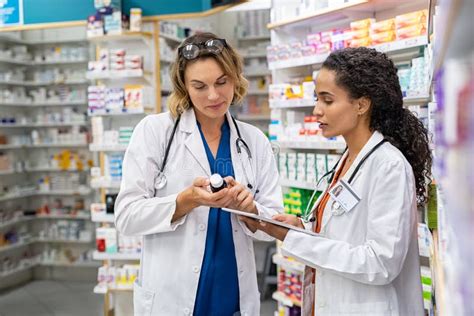 Two Pharmacists Working Together At Pharmacy Stock Image Image Of