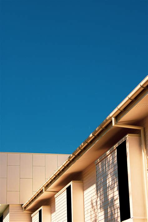 Brown Concrete Building Under Blue Sky During Daytime Photo Free Blue