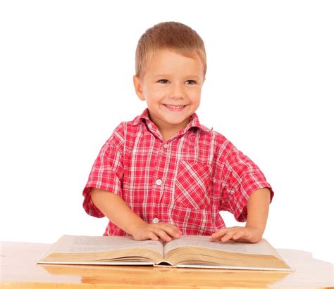 Smiling Little Boy Reading Book On The Desk Stock Photo Image Of