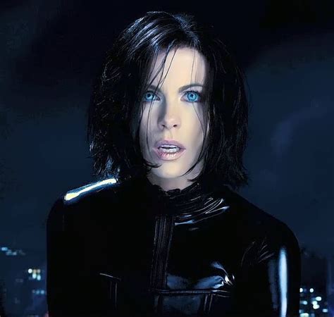 A Woman With Blue Eyes And Black Leather Outfit In Front Of A Cityscape