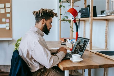 Black Man Remote Worker Using Computer In Workplace · Free Stock Photo