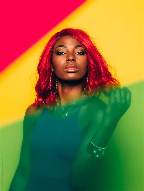 Beautiful Afro Woman Posing Over Yellow Background With Green And Red