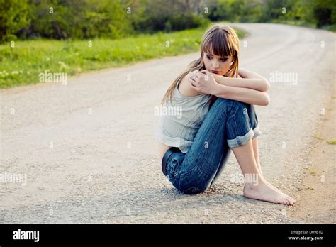 Sad Girl Sitting Down On Road Stock Photo Alamy