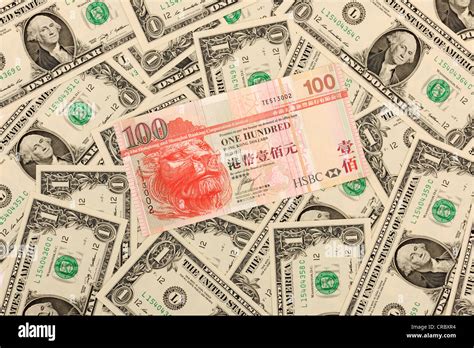 100 Hong Kong Dollar Banknote Lying On Top Of 1 Us Dollar Bills Stock