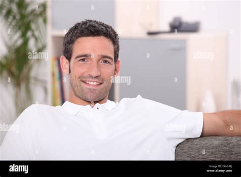 Man Sitting On Sofa Stock Photo Alamy