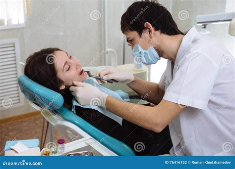 Professional Dentist Doing Teeth Checkup On Female Patient Dental