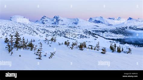 Distant Snowy Mountains Landscape And Winter Sunset Alpenglow At Stock