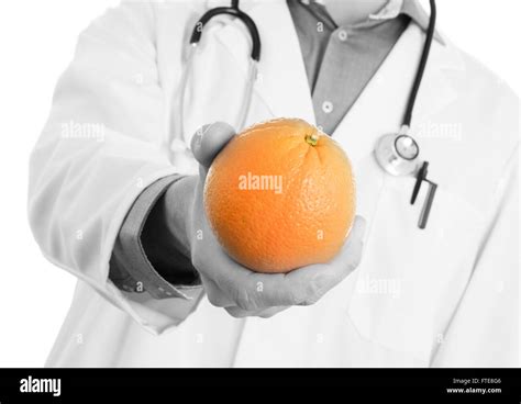 Nutritionist Doctor Giving An Orange Isolated On White Stock Photo