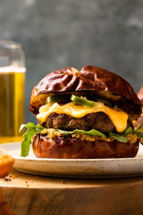 Beer Cheese Burgers On Pretzel Buns With Caramelized Beer Onions And