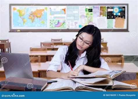 Student Writing On Books In The Classroom Stock Image Image Of
