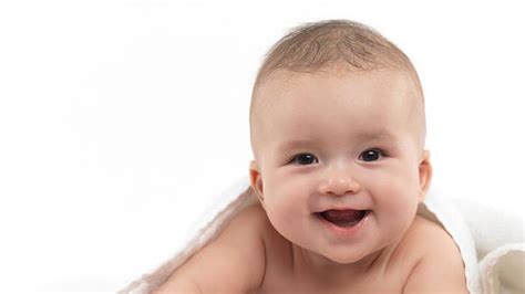 Closeup View Of Smiling Cute Baby Is Covering With White Towel In White