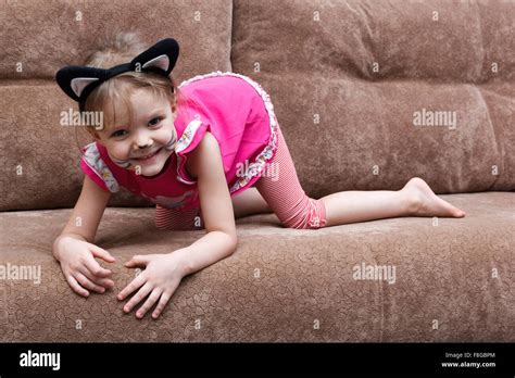 Little Girl With Cat Face Painting On A Couch Stock Photo Alamy