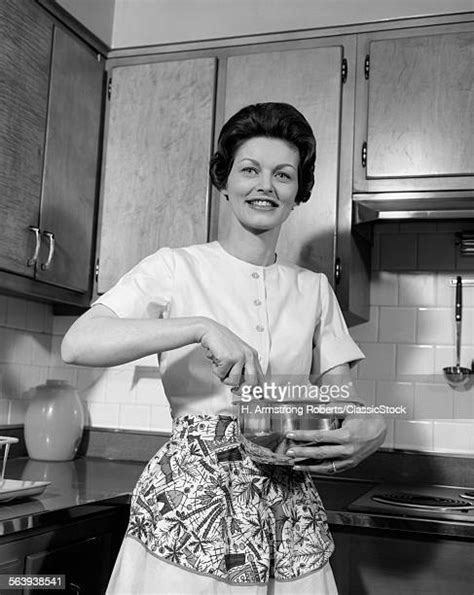 1960s Woman Wearing Apron In Kitchen Photos And Premium High Res