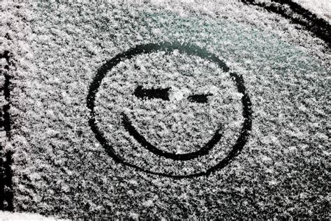 A Smiley Face Drawn On Snow Covered Glass Stock Photo Image Of