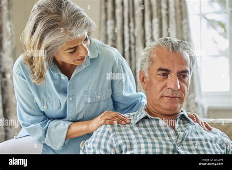Mature Woman Comforting Man With Depression At Home Stock Photo Alamy