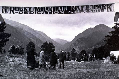 An Old Black And White Photo Of People In The Mountains With A Rocky