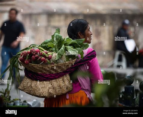 Indigenous Woman In Traditional Andean Dress Costume Carrying Basket
