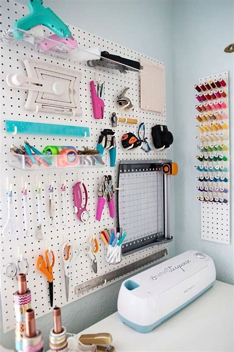 A Pegboard With Scissors And Other Crafting Supplies Hanging On Its Wall