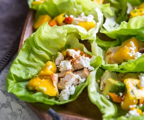 In a medium bowl stir together all of the ingredients for the mango salsa, set aside. Chicken Lettuce Wraps with Mango Salsa | LemonsforLulu.com