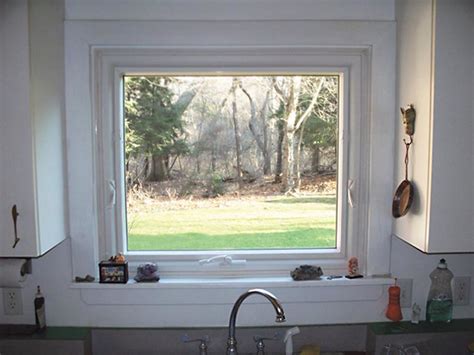 Lovely kitchen features a farmhouse sink and a gooseneck. Awning Replacement Window Over Sink | Converted two ...