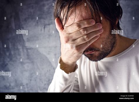Depressive Man Crying With Hand Covering His Face Looking Upset And