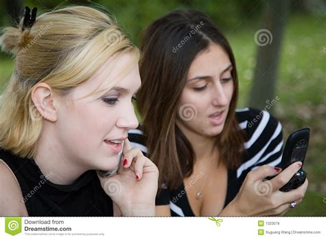 Friends On Cell Phone Together Beautiful Young Blonde And Brunette