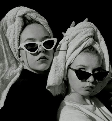Two Women With Towels On Their Heads Are Posing For A Black And White