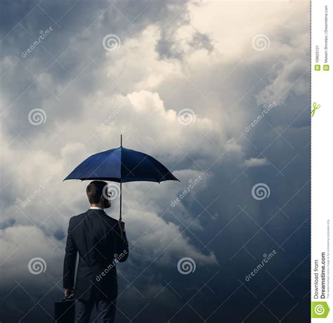 Businessman With Umbrella Standing Over Stormy Background Stock Image