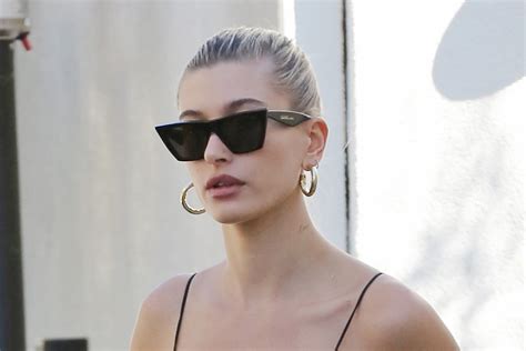 hailey baldwin gets daring in a dipping latex bodysuit and classic stilettos