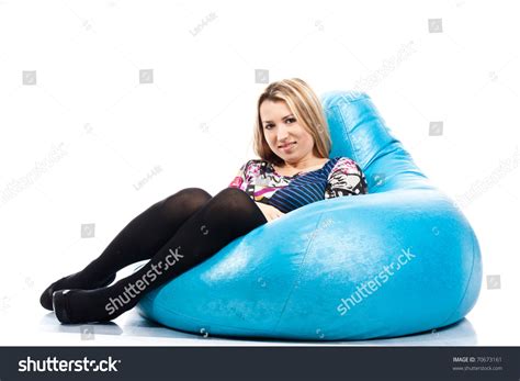 Portrait Of A Beautiful Young Girl Sitting On A Bean Bag Isolated On