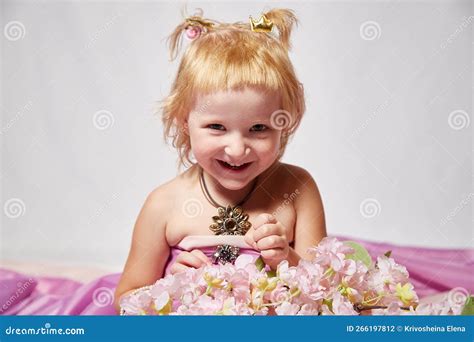 Portrait Of Cute Kid Girl Posing In Pink Beautiful Dress On A White