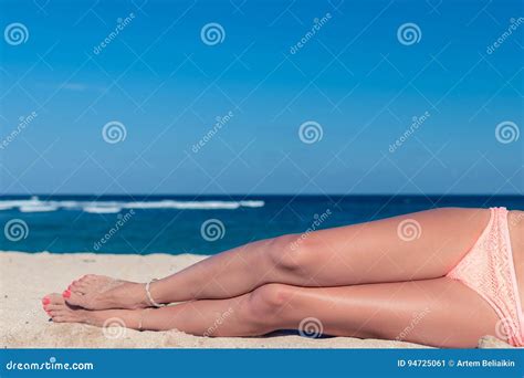 Tanned Legs Of A Woman Against The Sea Tropical Beach Scene Bali