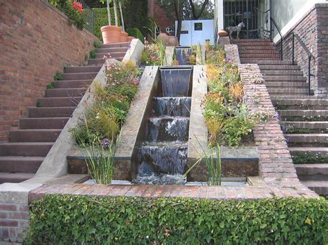 Having water feature, a small pond like structure, right below modern staircase is yet another way of bringing this natural element right into your home. Waterfall Stairway | This home in Pacific Heights has a ...