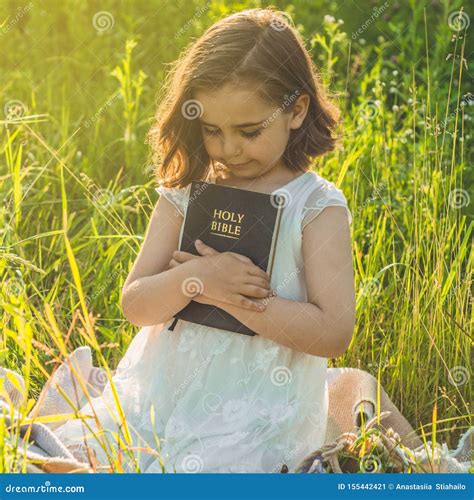 Christian Girl Holds Bible In Her Hands Reading The Holy Bible In A