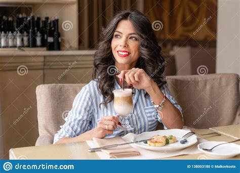 Beautiful Young Woman Enjoying Coffee Cappuccino Or Latte In A Glass