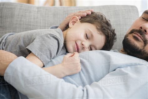 Caucasian Father And Son Napping On Sofa Stock Photo Dissolve