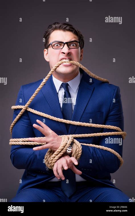 Businessman Tied Up With Rope Stock Photo Alamy