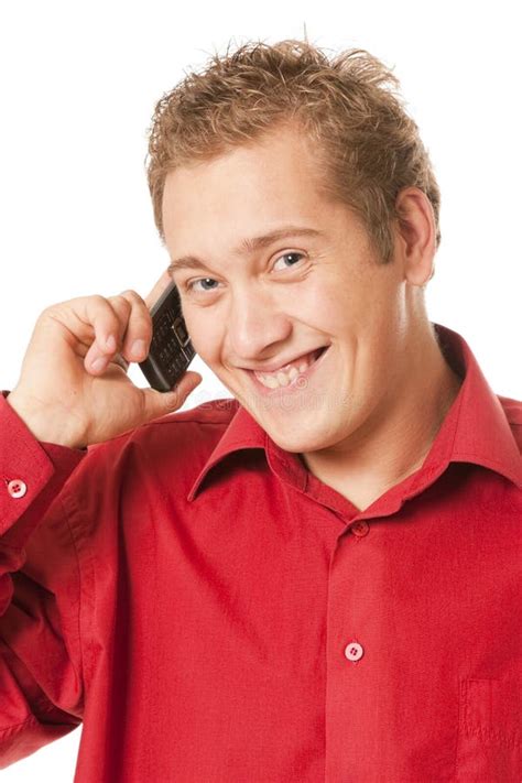 El Hombre Joven Habla Por Un Teléfono Móvil Foto De Archivo Imagen De