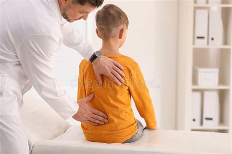 Chiropractor Examining Child With Back Pain Stock Photo Image Of