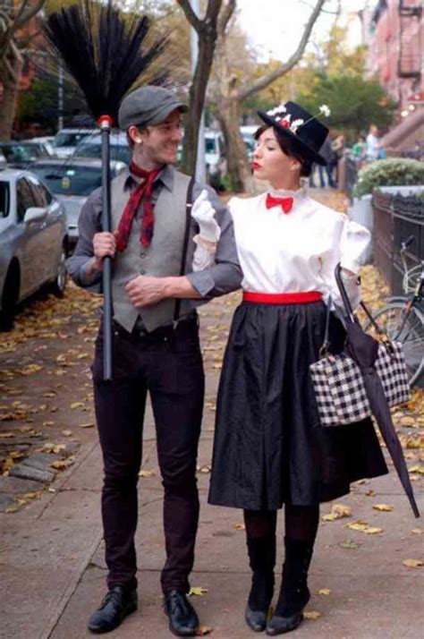 A Man And Woman Dressed In Costumes Walking Down The Street