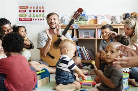 Nursery Children Playing With Musical Instruments In The Classroom