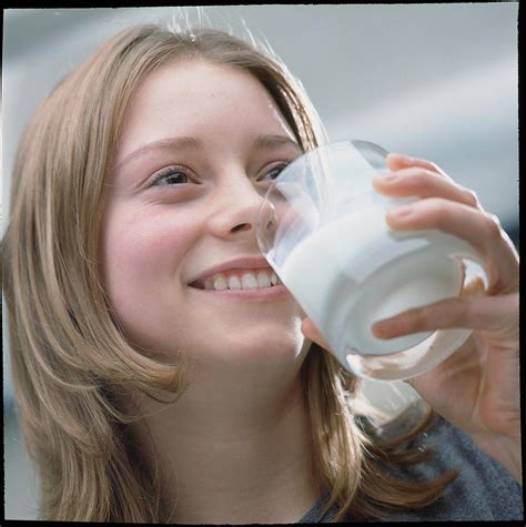 Teenage Girl Drinking A Glass Of Milk Photograph By Damien Lovegrove