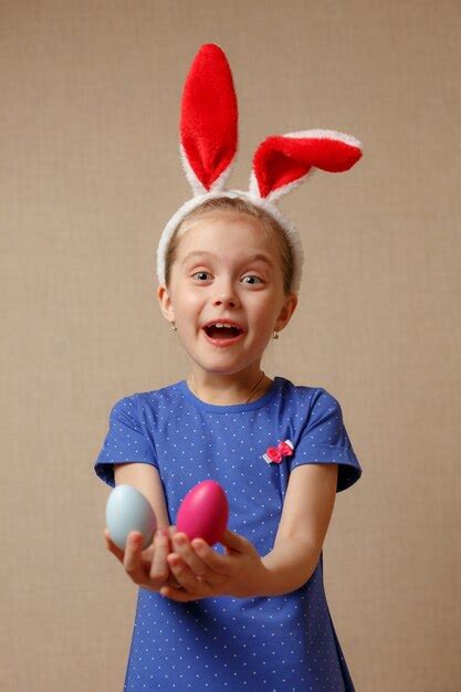 Premium Photo Cute Smiling Little Girl With Colorful Easter Eggs