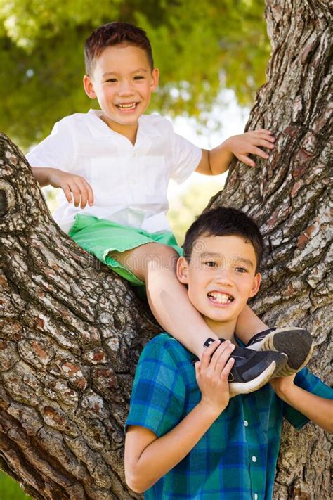 Outdoor Portrait Of Mixed Race Chinese And Caucasian Brothers Having