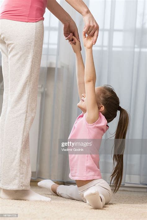 Girl Doing The Splits With A Little Help From Her Mother Photo Getty