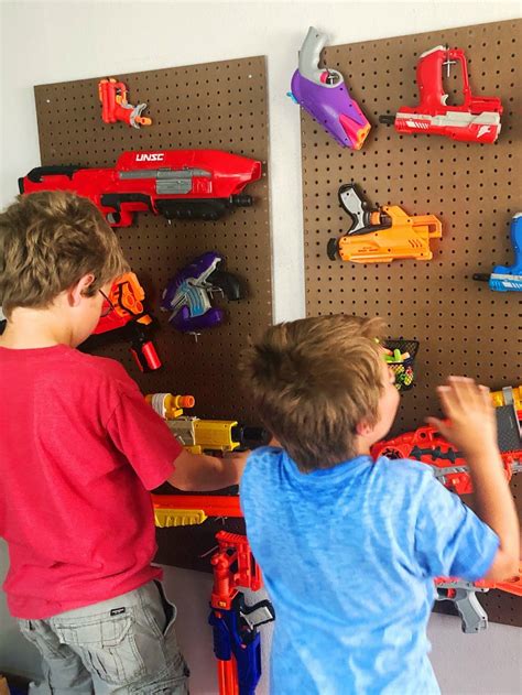 Have a bunch of nerf guns laying around and want to get them out of the way and also add an awesome nerf gun rack to your. DIY Pegboard NERF Gun Storage - Moments With Mandi