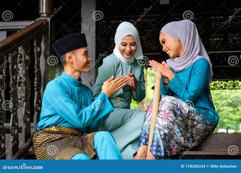 A Group Of Malay Muslim People In Traditional Costume Showing Greeting