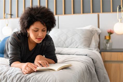 Relaxed Woman Reading Book And Lying In The Bedroom Stock Image Image