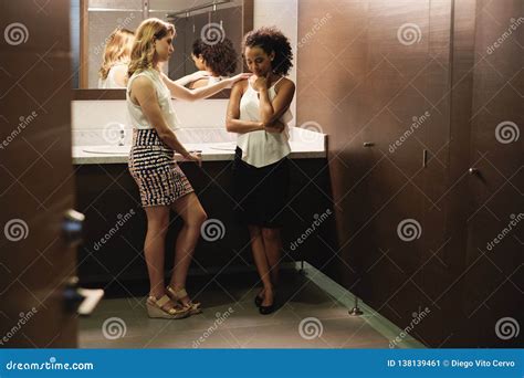 sad girl crying for problems in office toilets with friend stock image image of comforting