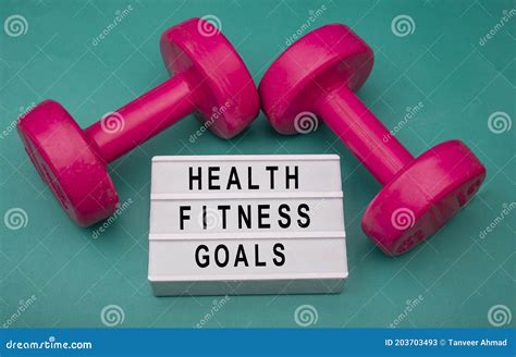 Health And Fitness Goals Sign With Dumbbells Around Stock Image Image